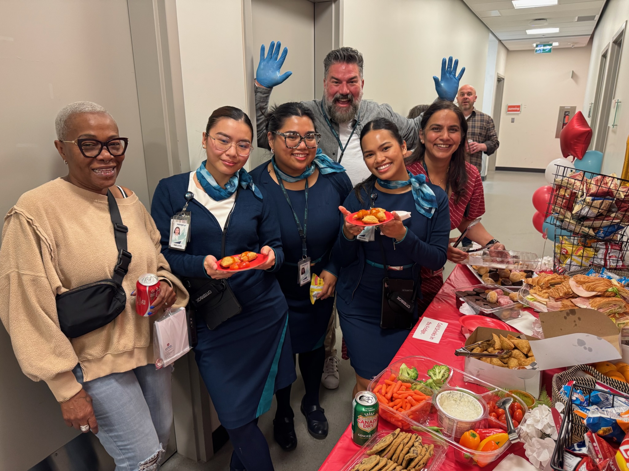 Local 531 members at the YYC Airport in front of a table of food. 