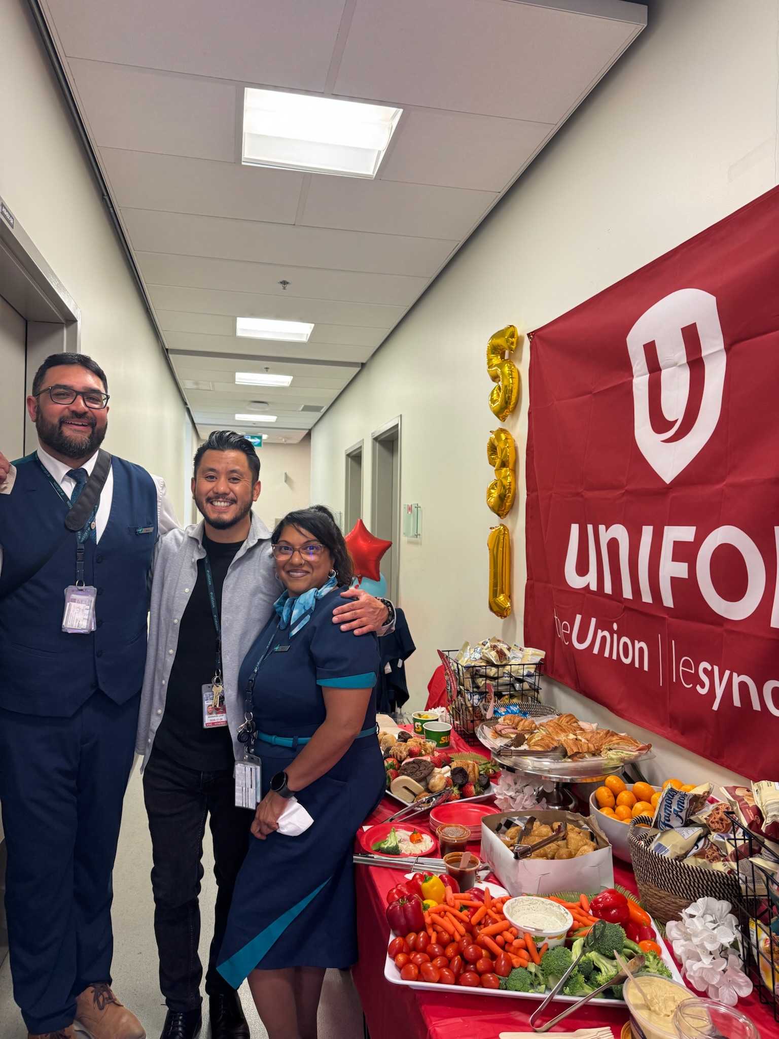 Three Unifor Local 531 members stand together