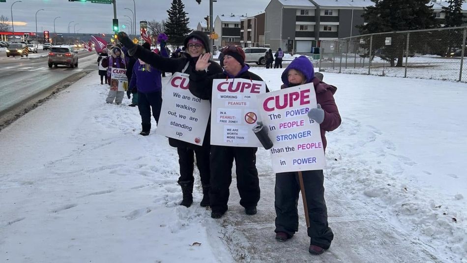 striking workers in front of a school in Fort McMurray